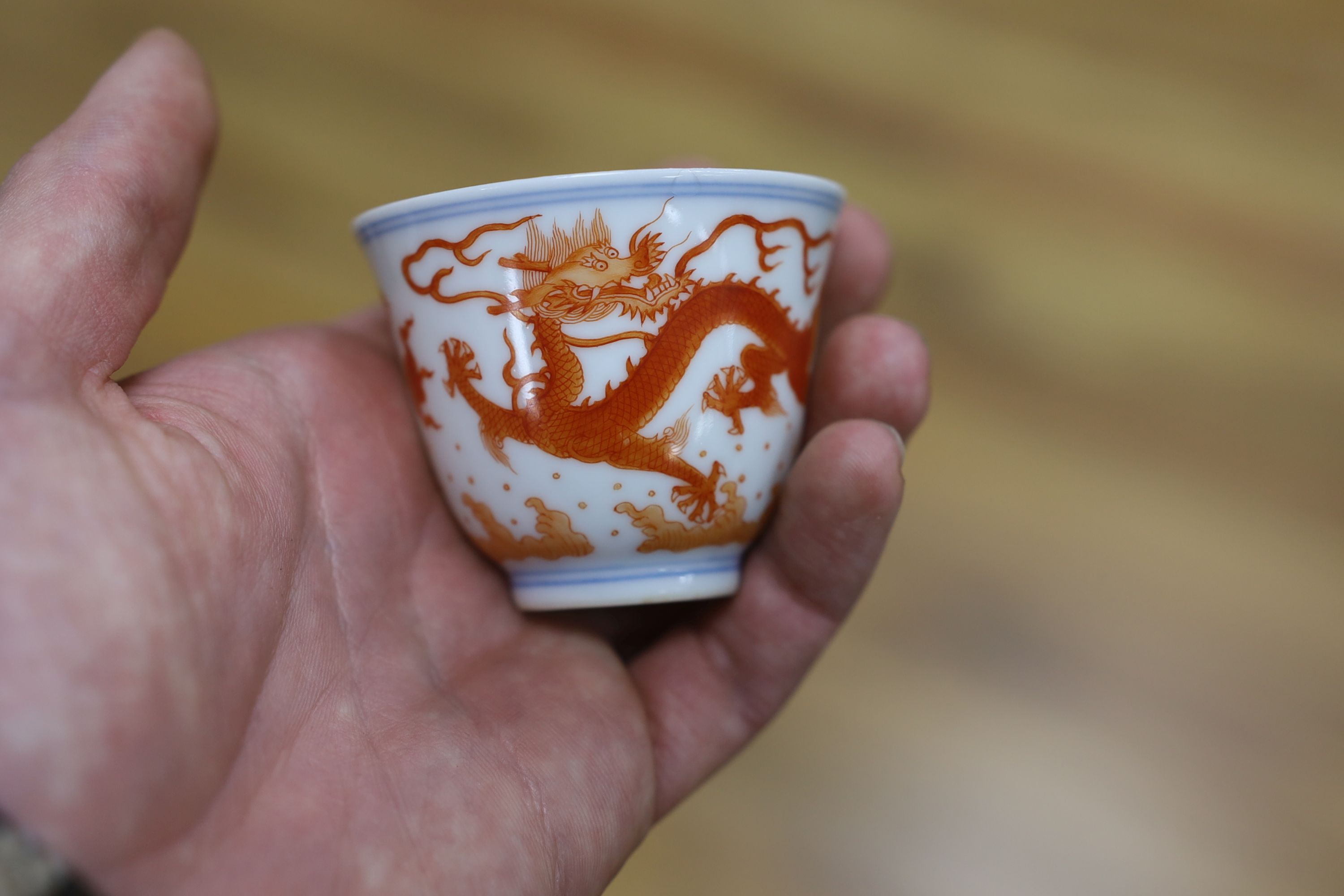 A Chinese iron red enamelled ‘dragon’ tea bowl, 5cm high